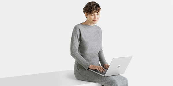 Woman with Surface Pro 10 sitting